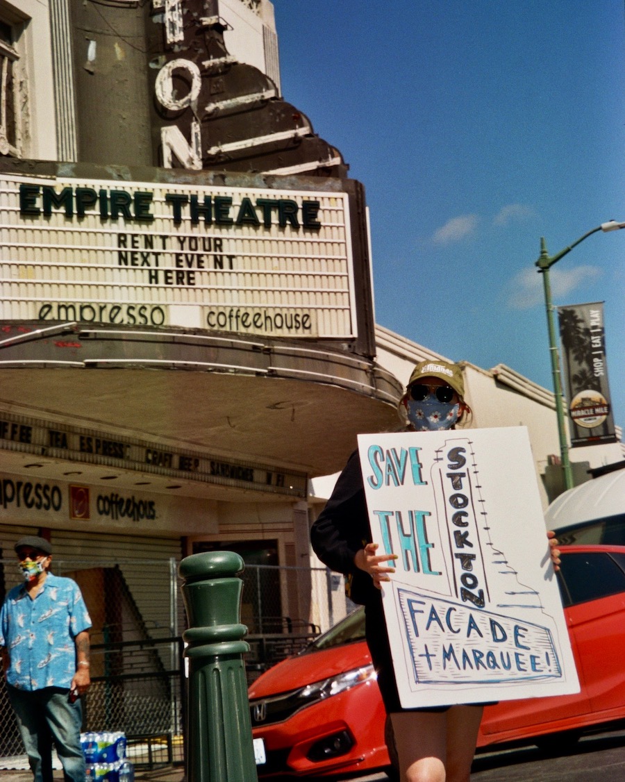 Local musician Cheyenne Wells protesting to save the façade.